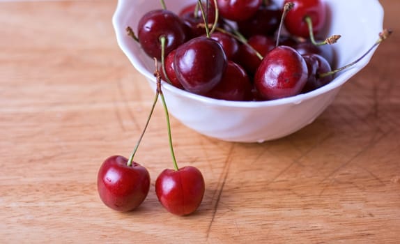 ripe cherries on the wood table