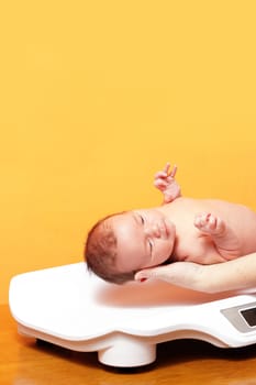 baby boy on weight scale