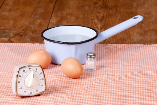 Two eggs with pot and egg timer