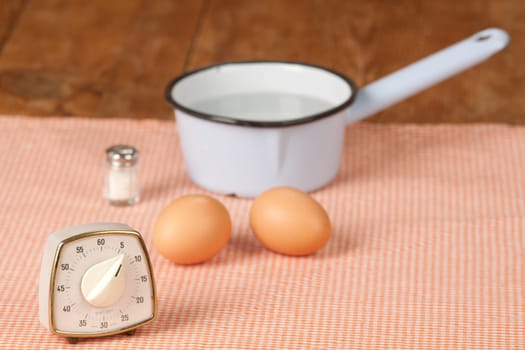 Two eggs with pot and egg timer