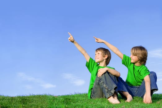 kids or children pointing at copy space outdoors in summer