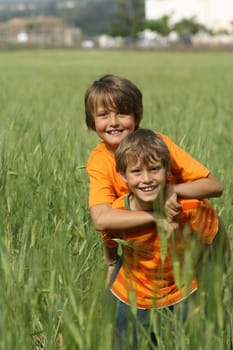 happy healthy fit active children or kids playing piggyback outdoors