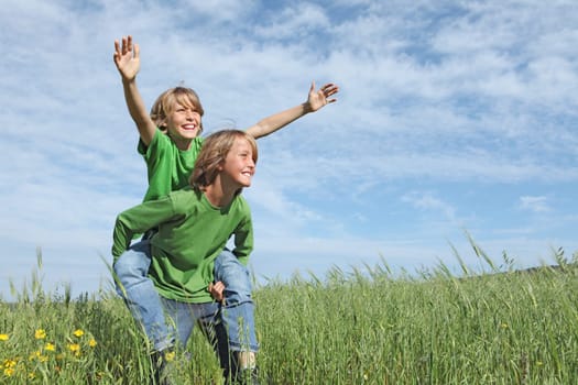 healthy happy fit active kids playing piggyback outside in summer
