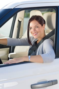 Attractive elegant businesswoman driving luxury new car concentrating