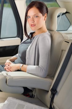 Executive businesswoman sitting in car leather backseat wear suit