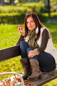 Autumn fashion outfit beautiful woman eat apple sunset nature park