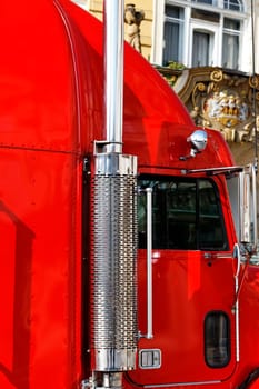part of big red truck cabin on the road