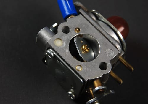 Stock pictures of a small gas engine and a carburetor
