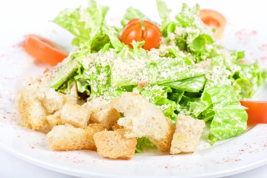 salad of meat, vegetable and dried crust dish close up on a white background