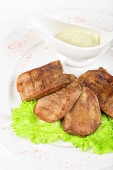 Beef tongue closeup with sauce isolated on a white background