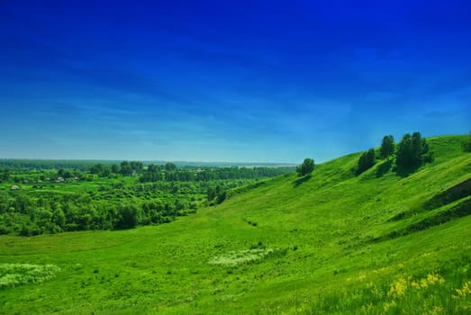 summer landscape of green valley and blue sky