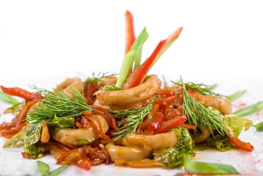 Seafood salad with squid and vegetables closeup