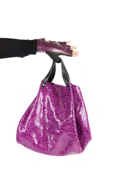 purple women bag at hand isolated on a white background