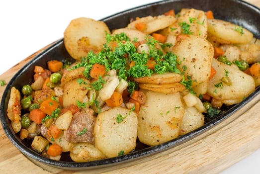 Fried potato with meat and vegetables on a white