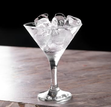 ice at cocktail glass at bar table