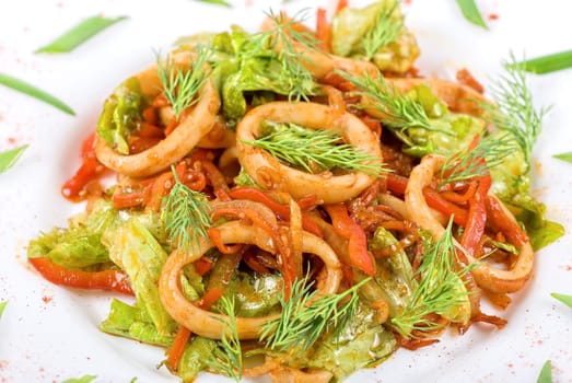 Seafood salad with squid and vegetables close up