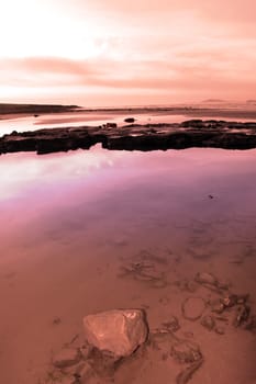 mud and rocks on beale beach co kerry ireland on a cold winters day