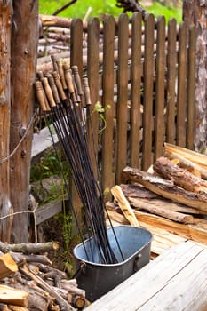 Wooden fence and steel sticks for barbecue