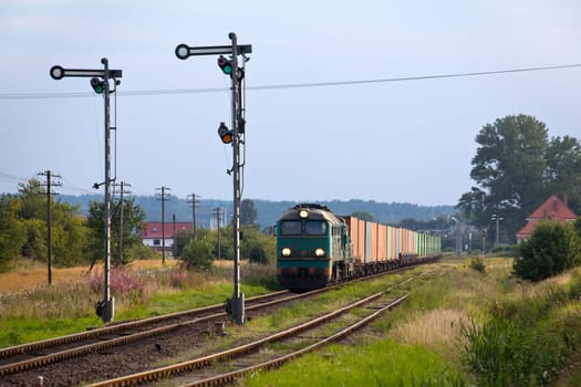 Freight train hauled by the diesel locomotives stopped on the station