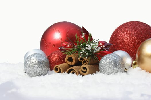 Decorative Christmas baubles in snow