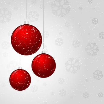 Hanging Christmas baubles on a silver snowflake background