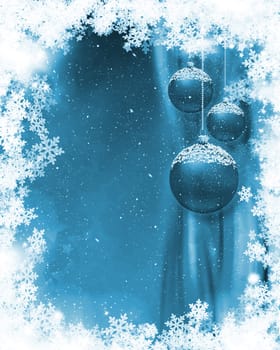 Hanging Christmas baubles on a snowflake background