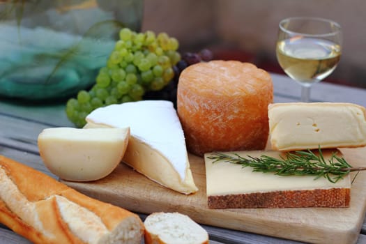 Cheese platter with wine,grapes and baguette