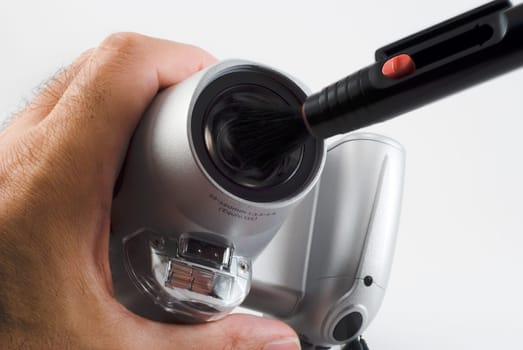 The photographer cleans an objective of a digital camera