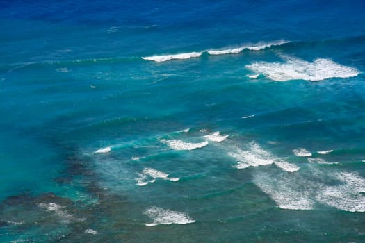 Surf from above blue to greenish water