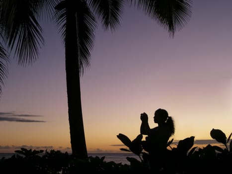 Silhouette of a woman in profile at sunset