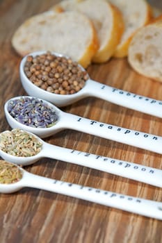 Old table-top selection of herbs and grains in measuring spoons