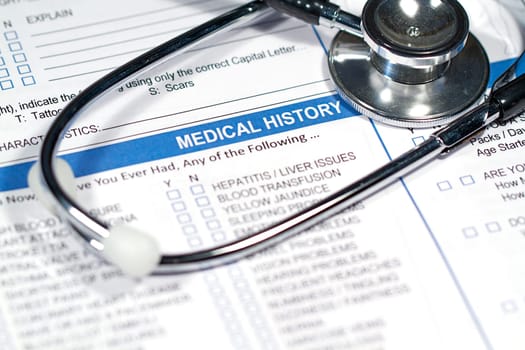 Close up of a Medical History form and a doctor&#039 s Stethoscope