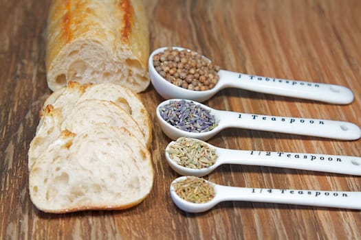 Old table-top selection of herbs and grains in measuring spoons