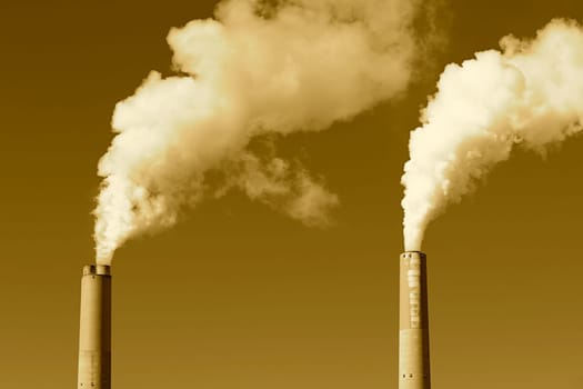 A tall smokestack spewing out dirty polluted smoke