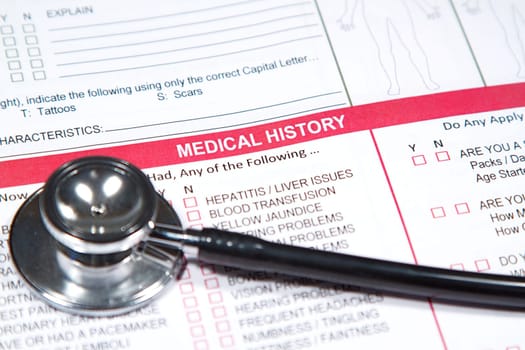 Close up of a Medical History form and a doctor&#039 s Stethoscope