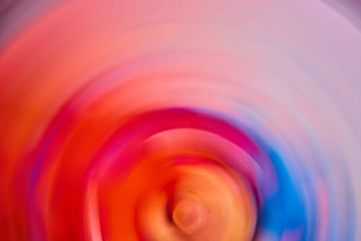 Image of Abstract gentle swirl of orange and red with a hint of blue on right side in background asset