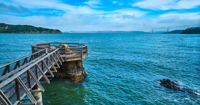 Image of Elephant Rock aerial with choppy water across bay toward Golden Gate Bridge and blue sky