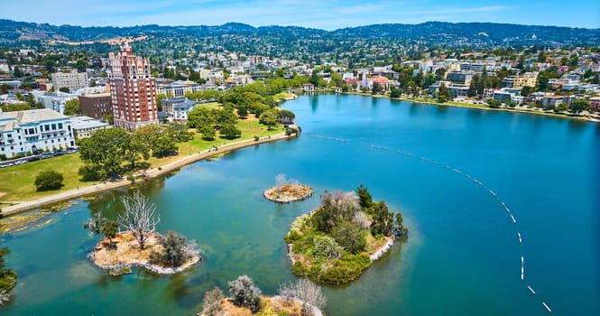 Image of Pelican Island on Lake Merritt with aerial of Oakland City residential area