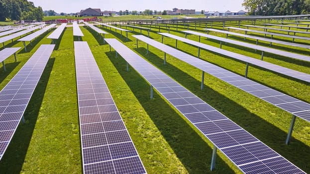 Image of Sunlight hitting solar panels on solar farm in low flying aerial