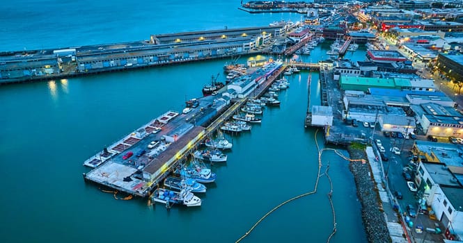 Image of Aerial over Fishermans Wharf and Pier 39 at dusk with yellow street lights on