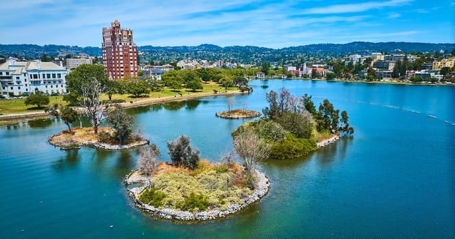 Image of Pelican Island on Lake Merritt with low aerial of Oakland City residential area