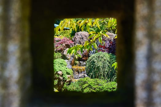 Image of View of gorgeous waterfall in garden through square opening