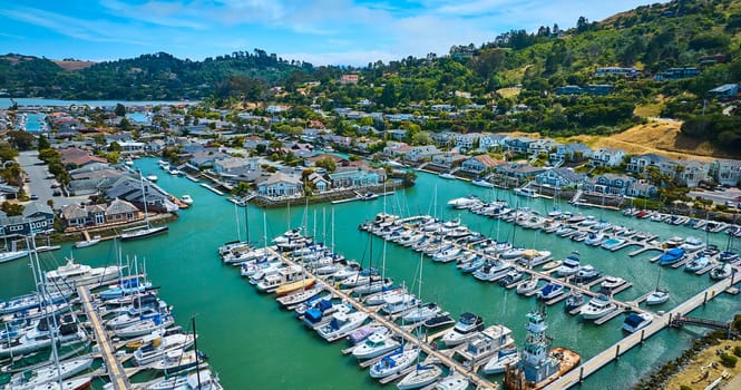 Image of Aerial Paradise Cay Yacht Harbor full of boats with wide view of rich waterfront properties