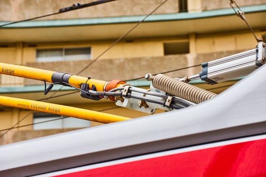 Image of Top of city bus close up of cables connecting to clean energy electric wires abstract view