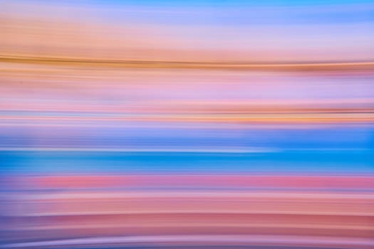 Image of Abstract streaks of pastel colors with blue framed by red and purple with orange on top