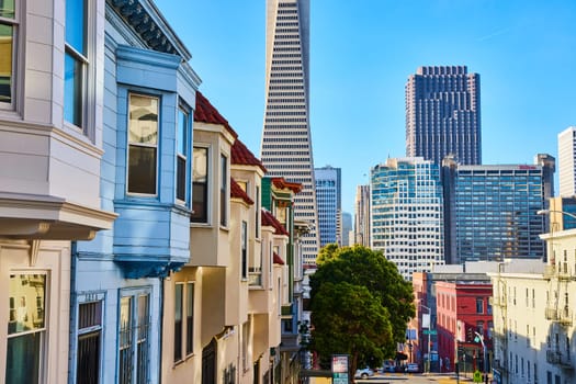 Image of Transamerica Pyramid behind row of houses leading eye to downtown skyscrapers