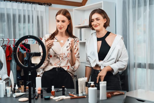 Woman influencer shoot live streaming vlog video review makeup utmost social media or blog. Happy young girl with cosmetics studio lighting for marketing recording session broadcasting online.