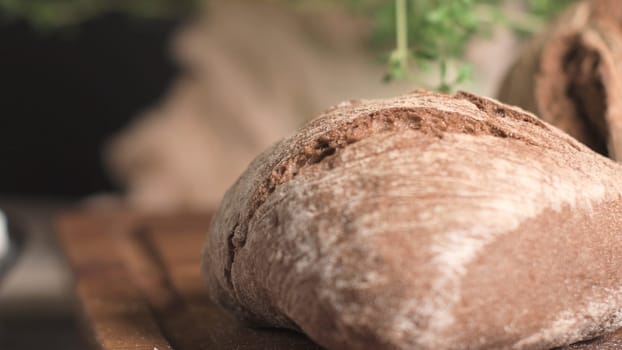 Malt loaf bread on rustic wooden table.