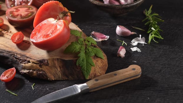 Large variety of tomatoes on rustic kitchen counter. Preparation of tomato sauce.