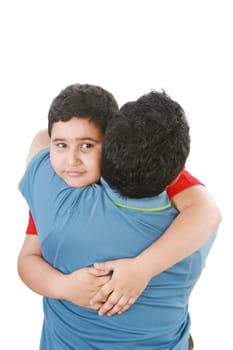 Portrait of a young boy hugging his father against white background